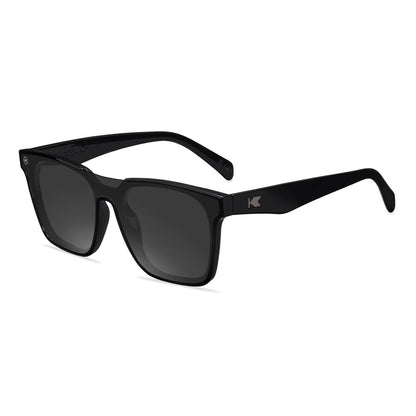 Sunglasses with a black frame with polarized black lenses, flyover