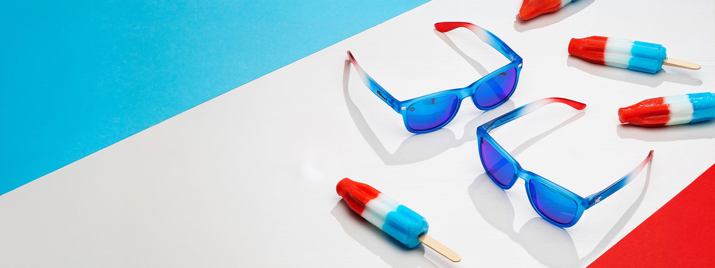 Rocket Pop Premiums and Fast Lanes sunglasses by Knockaround on a red, white, blue background with Rocket Pop popsicles