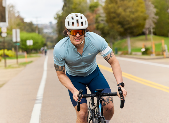 Man cycling while wearing Knockaround Campeones sunglasses