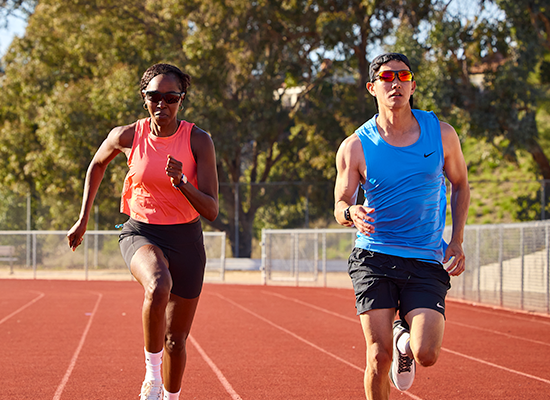Man and woman running while wearing Knockaround Kinetics sunglasses